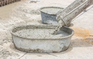 Pouring of wet concrete form concrete mixer into the tub