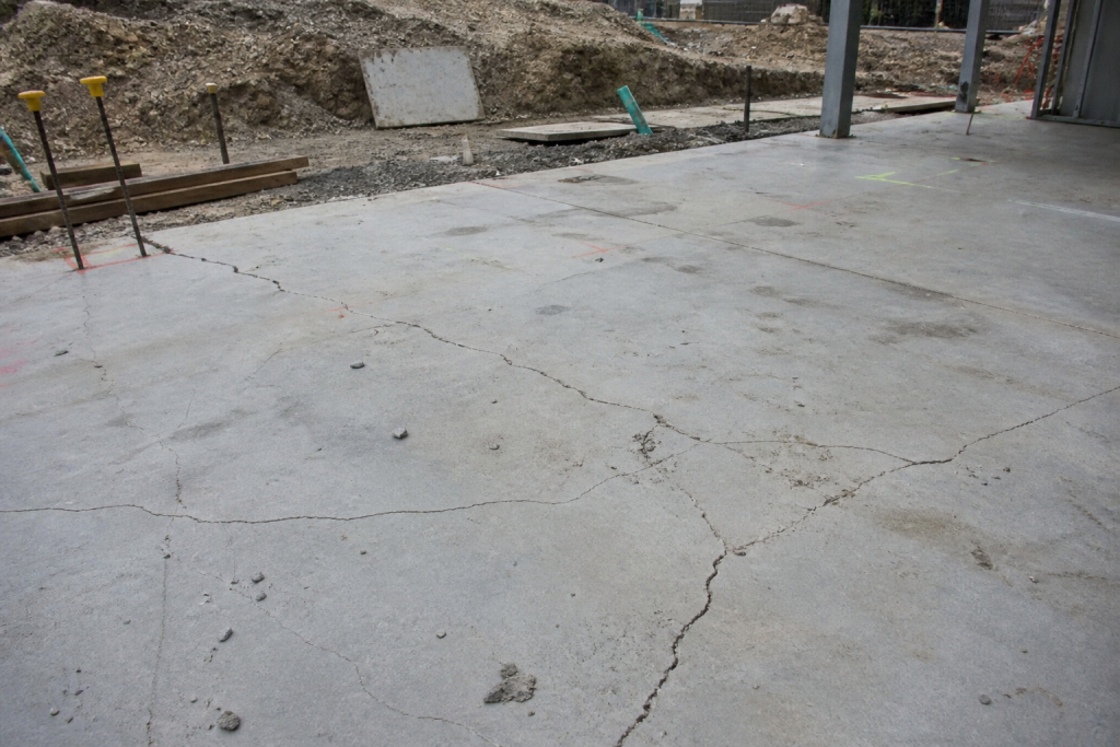 Cracked concrete slab on a Brisbane construction site showing failure from low-quality mix