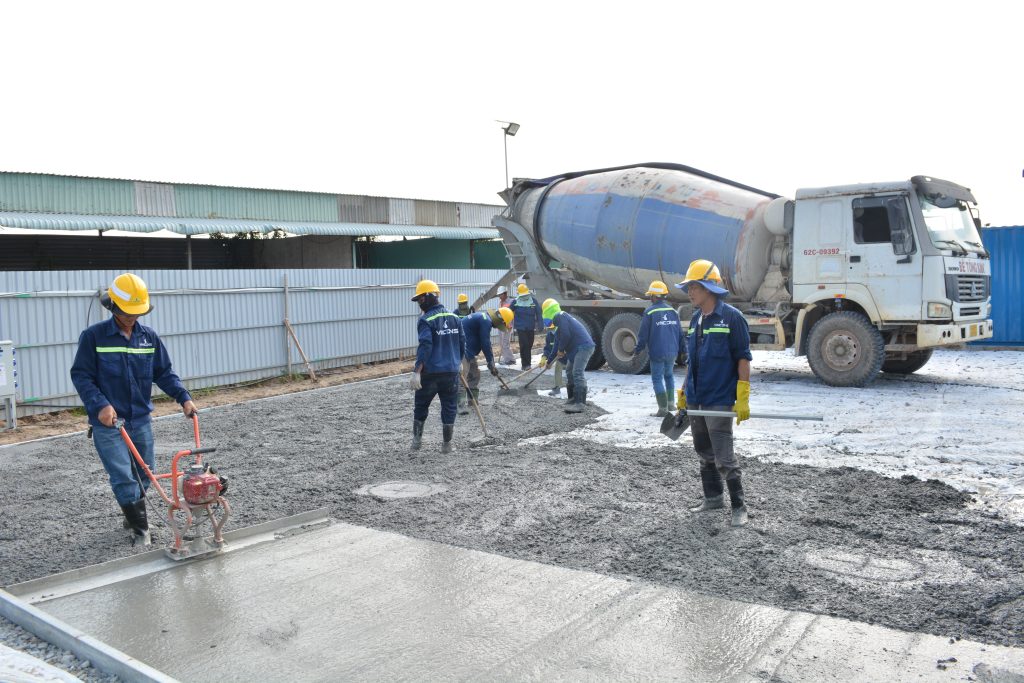 Mobile concrete batching plant operating on a Sydney construction site with cement silo and concrete pump.