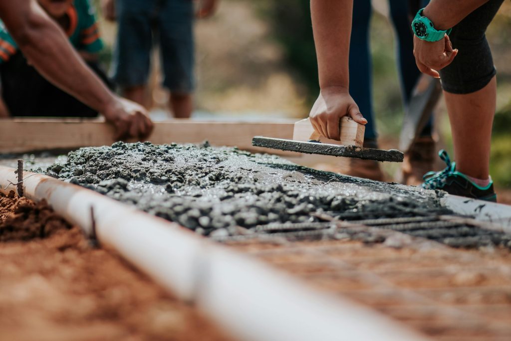 Concrete slab being poured using the correct concrete mix ratio for long-lasting strength and durability.